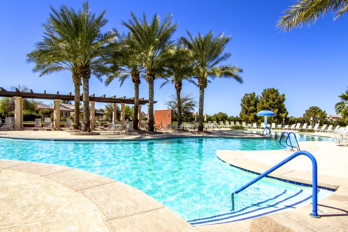 A resort-style outdoor pool is surrounded on three sides by a scenic 50-acre lake.
