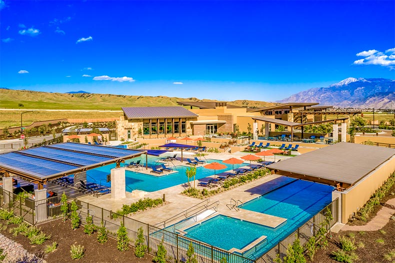 Aerial view of the Altis clubhouses and outdoor pool and patio with mountains in the background