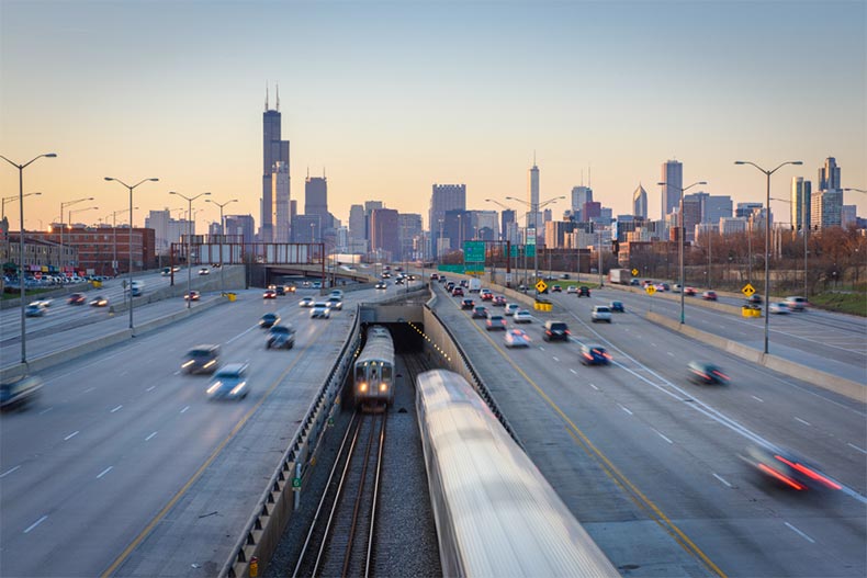Highway and CTA trains with Chicago skyline