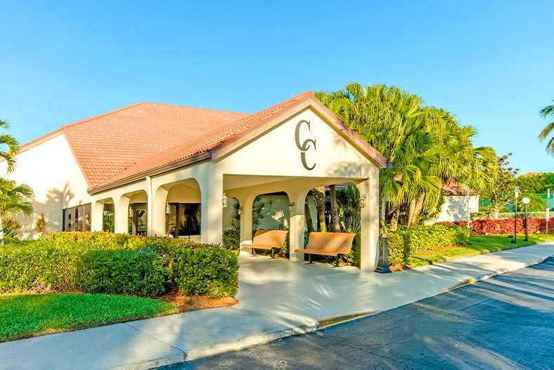 Exterior photo of the clubhouse in Cinnamon Cove on a sunny, cloudless day, located in Fort Myers, Florida