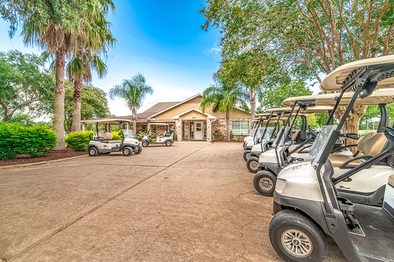 Golf carts lined up outside the golf course entrance at CountryPlace in Pearland, Texas