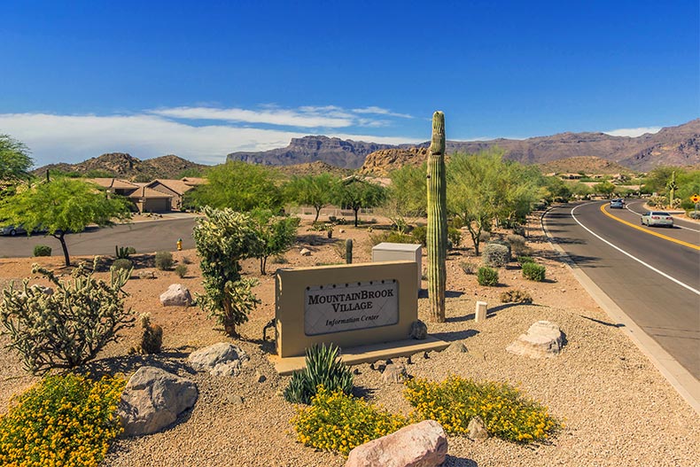 The community sign surrounded by desert landscape at Mountainbrook Village in Gold Canyon, Arizona