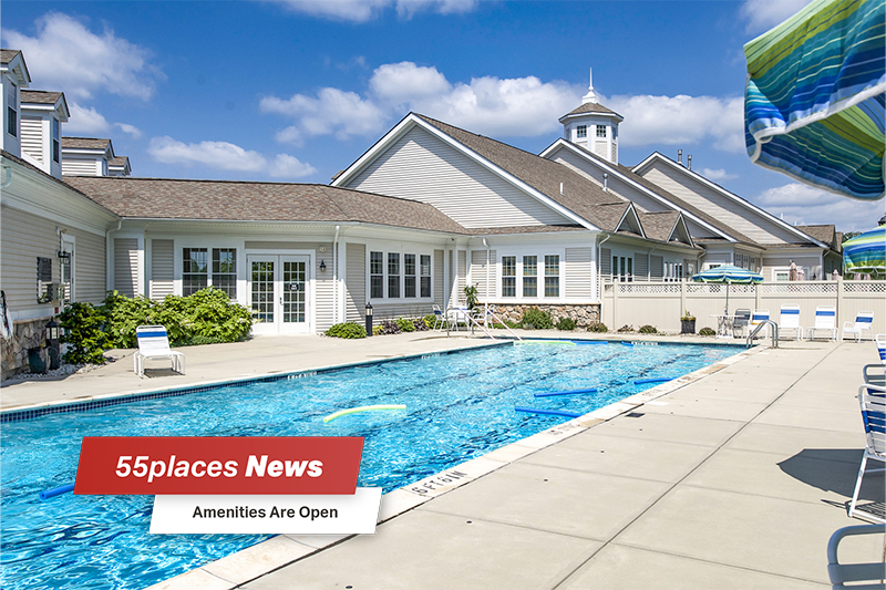 "Amenities Are Open" banner over the outdoor pool at Del Webb Chauncy Lake in Westborough, Massachusetts