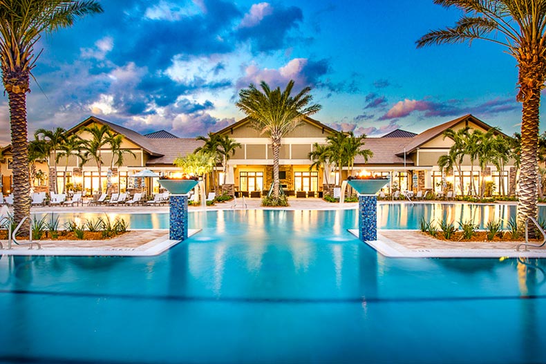 Palm tress surrounding the clubhouse and outdoor pool at Del Webb Lakewood Ranch in Lakewood Ranch, Florida