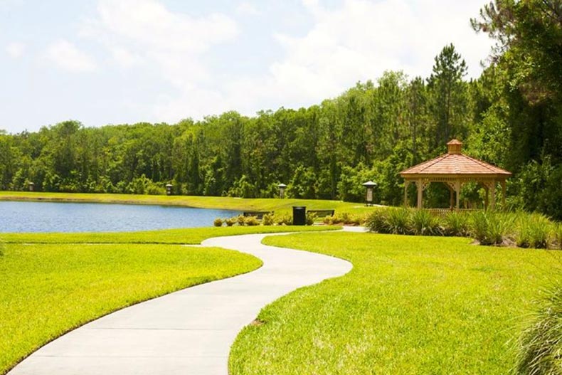 A picturesque pond, gazebo, and pathway on the grounds of Del Webb Ponte Vedra in Ponte Vedra, Florida