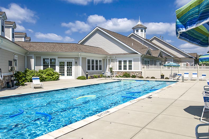 Outdoor pool and clubhouse in Del Webb Chauncy Lakes, MA