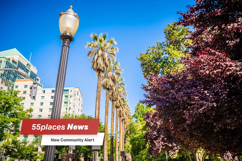 "New Community Alert" banner over a lamp post and palm trees in Sacramento, California