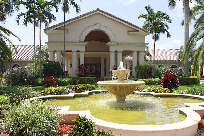 View of the fountain and greenery outside the clubhouse at The Cascades in Boynton Beach, Florida