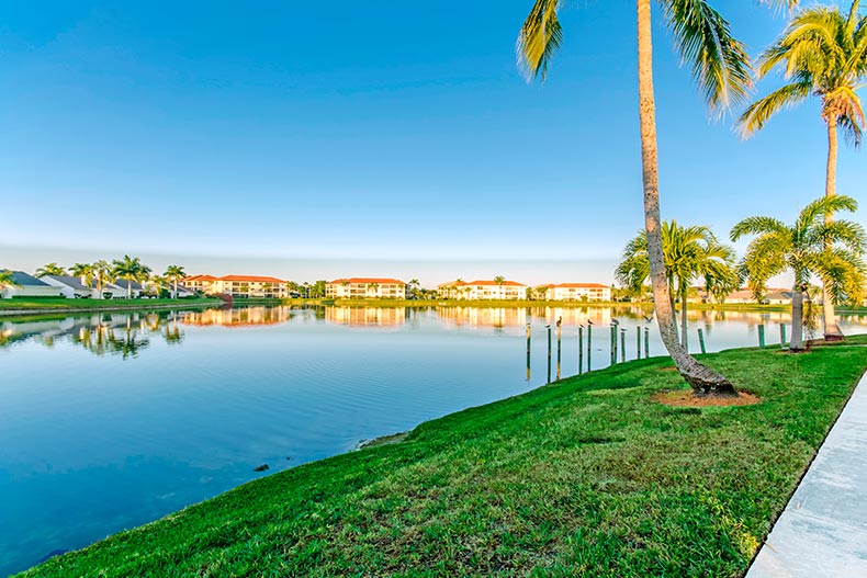 View of condo buildings across the fishing lake at Cinnamon Cove in Fort Myers, Florida