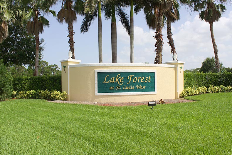 Palm trees and fresh-cut grass surrounding the community sign for Lake Forest in Port St. Lucie, Florida