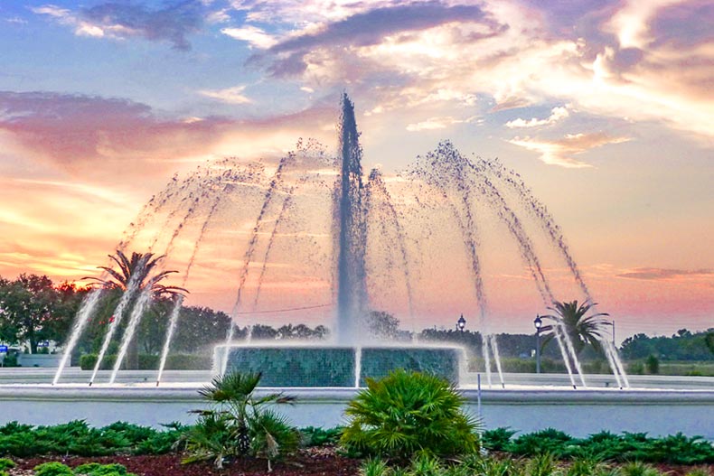 A sunset view of the fountain at the community entrance at Spruce Creek Country Club in Summerfield, Florida