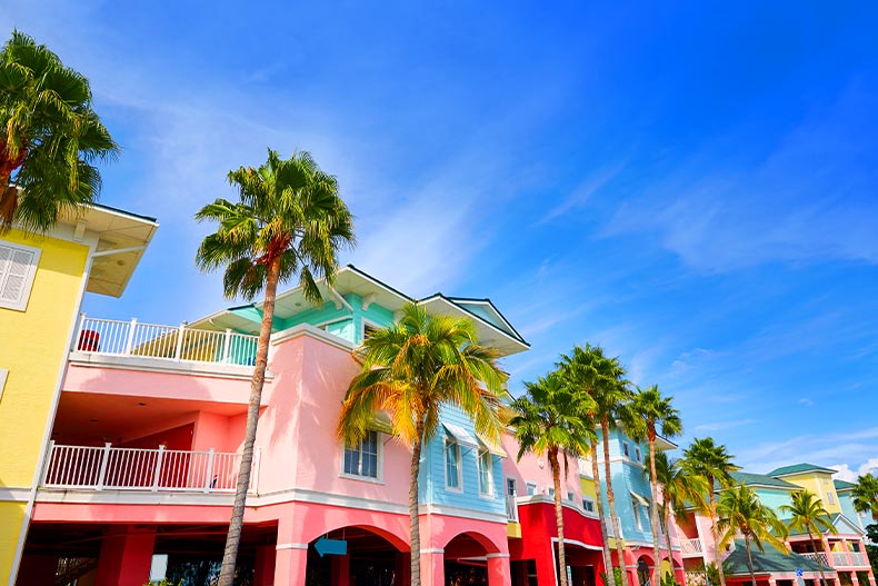 Worms-eye view of colorful buildings and palm trees in Fort Myers, Florida