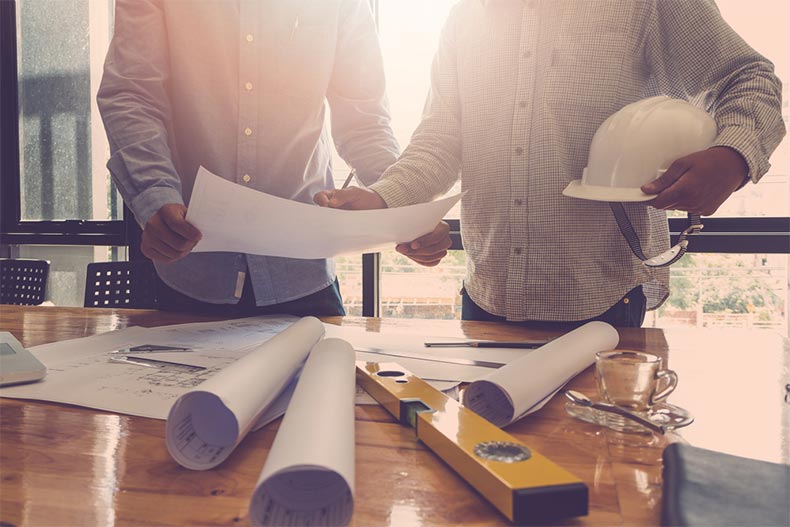 Architects working with blueprints in an office
