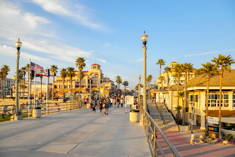 People walking down the pier at sunset in Huntington Beach, California