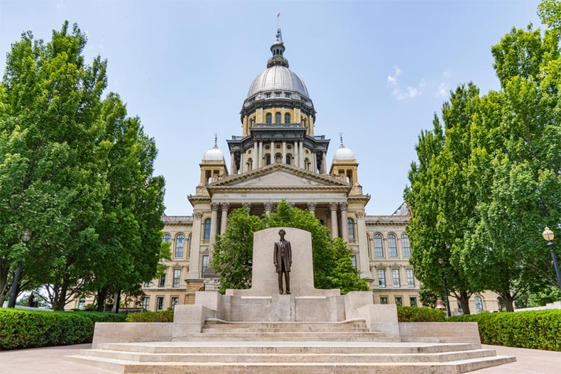 View of the Abraham Lincoln statue in front of the Illinois Capitol Building in Springfield, Illinois