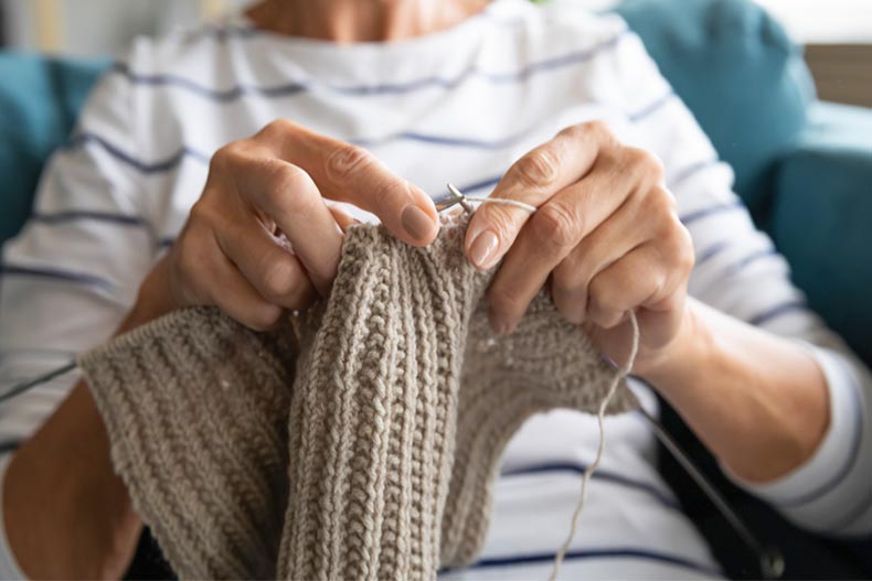 Close up of older woman knitting