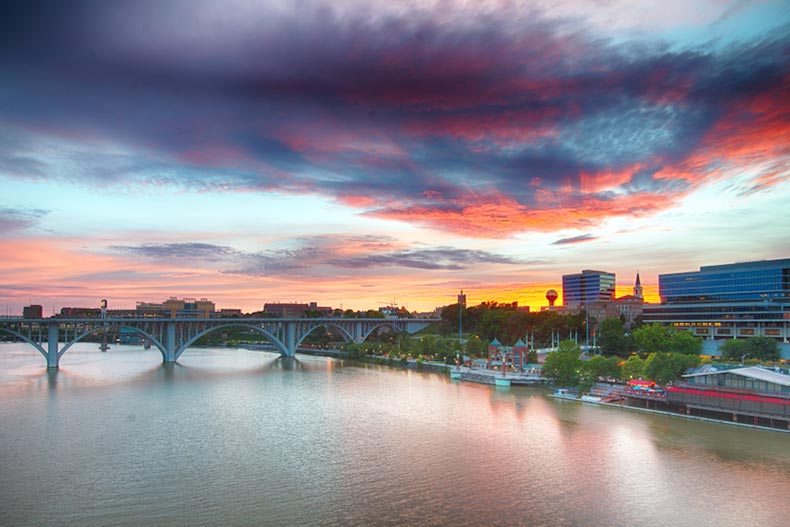 A colorful sunset over the river and skyline of Knoxville, Tennessee
