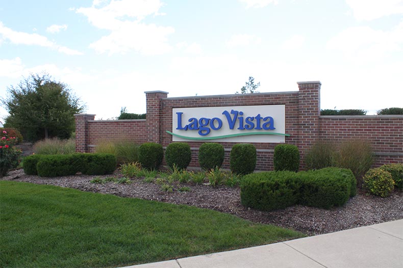 Greenery surrounding the community sign for Lago Vista in Lockport, Illinois