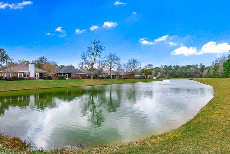 Houses beside a picturesque pond at LiveOak Village in Foley, Alabama