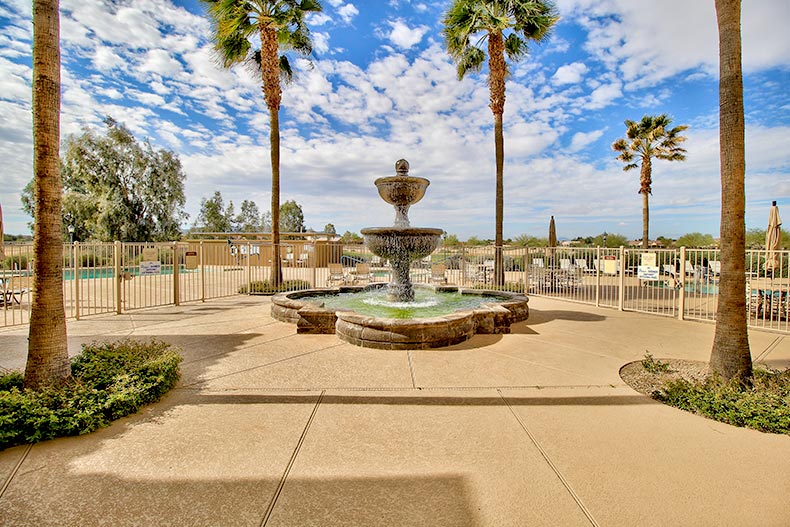 View of the fountain and palm trees near the entrance to Mission Royale in Casa Grande, Arizona