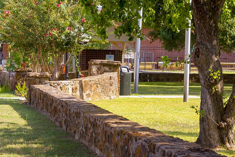 A stone wall along a public park in Montgomery, Texas