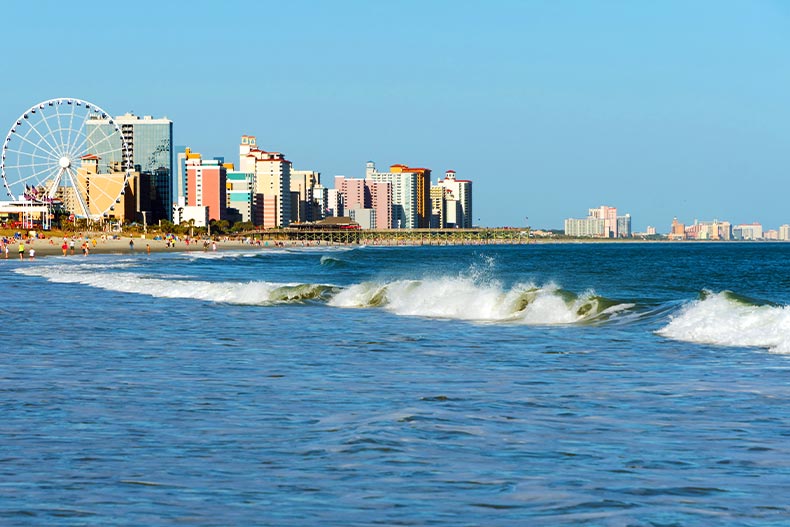 Photo of waves crashing on the Atlantic Ocean with the Myrtle Beach, South Carolina Boardwalk and skyline in the middle distance