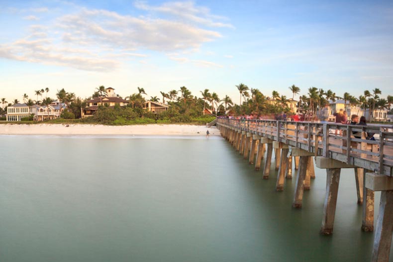 View of the Naples Pier and the shoreline at sunset in Naples, Florida