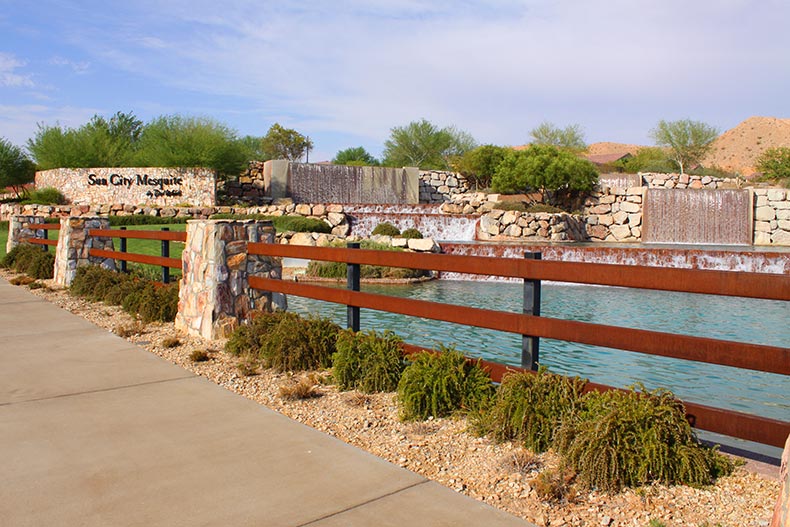 View of the pond and water features near the community sign for Sun City Mesquite in Mesquite, Nevada