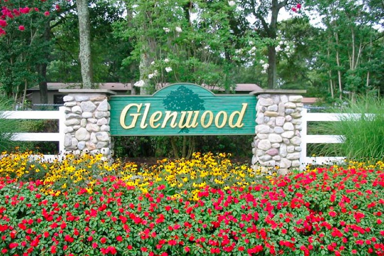 The community sign for Glenwood Village in Riverhead, New York surrounded by blooming flowers