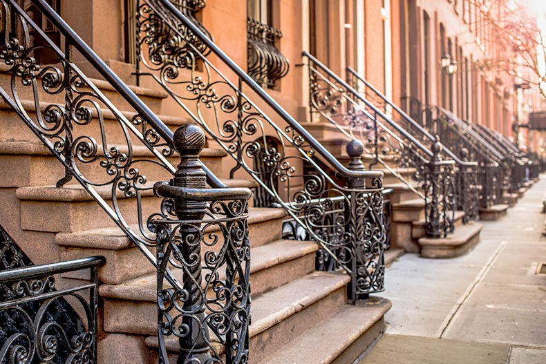 View of wrought iron railings outside brownstone apartment buildings in New York City