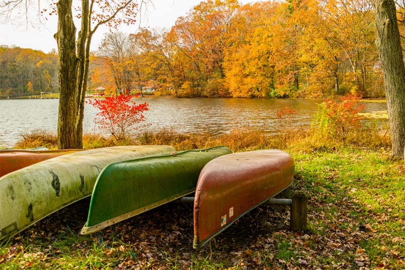 View of canoes at the edge of a scenic lake in mid-autumn in Lebanon County, Pennsylvania