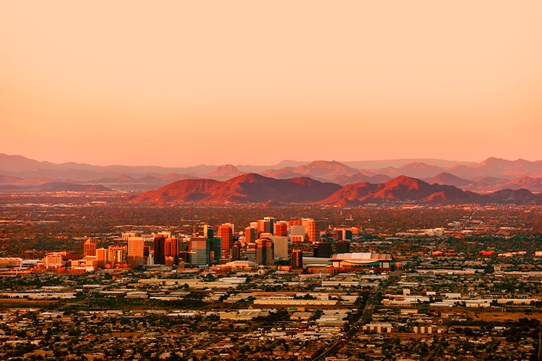 Aerial and distant view of Downtown Phoenix, Arizona with a mountain range in the distance