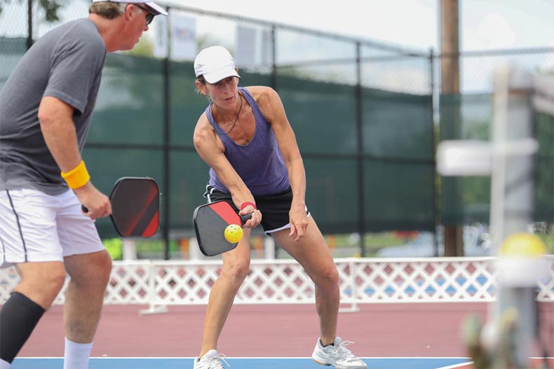 A mixed doubles team competes in a pickleball tournament