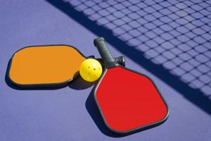 Paddles and a plastic ball are the main equipment necessities.  