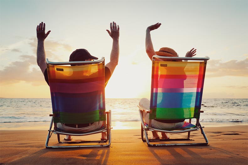 A happy couple celebrating their retirement at the beach