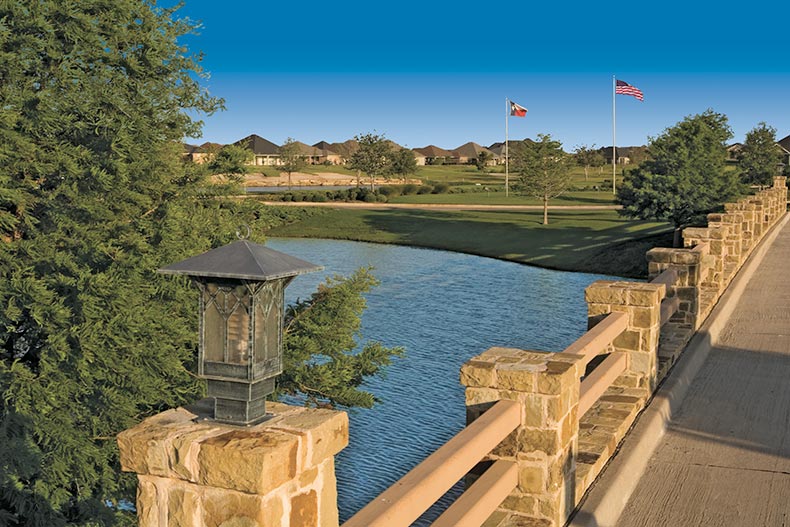 A stone bridge over a pond beside the golf course at Robson Ranch in Denton, Texas