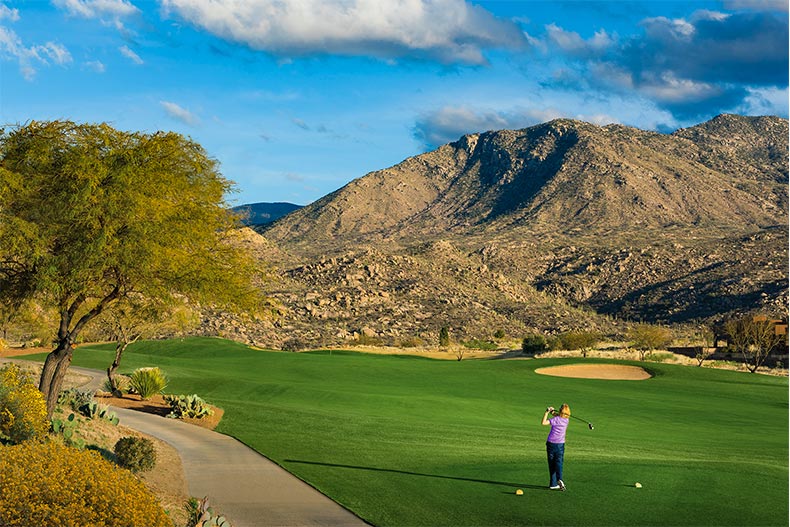 View of the community golf course with mountains in the background at SaddleBrooke in Tucson, Arizona