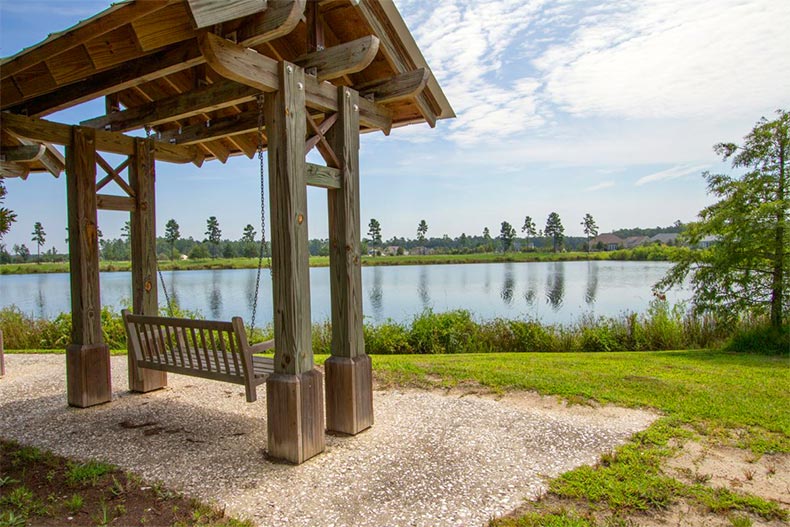 A wooden swing beside a picturesque pond at Hilton Head Lakes in Hardeeville, South Carolina