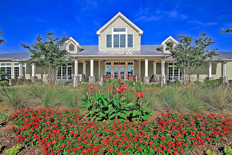 Red flowers in bloom outside the clubhouse at Cresswind Charleston in Summerville, South Carolina