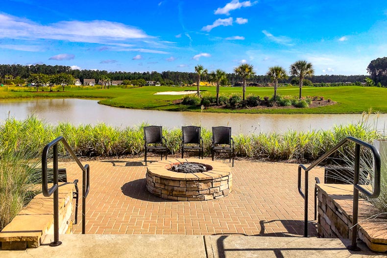 View of the outdoor patio overlooking a pond and a golf course at Sun City Hilton Head in Bluffton, South Carolina
