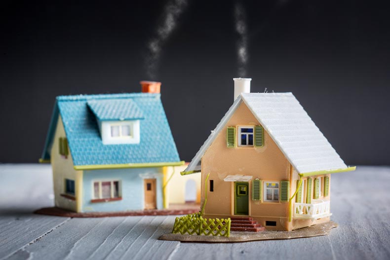 Two miniature houses against a black background