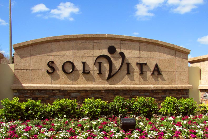 The brick community sign for Solivita with a garden in front, located in Kissimmee, Florida