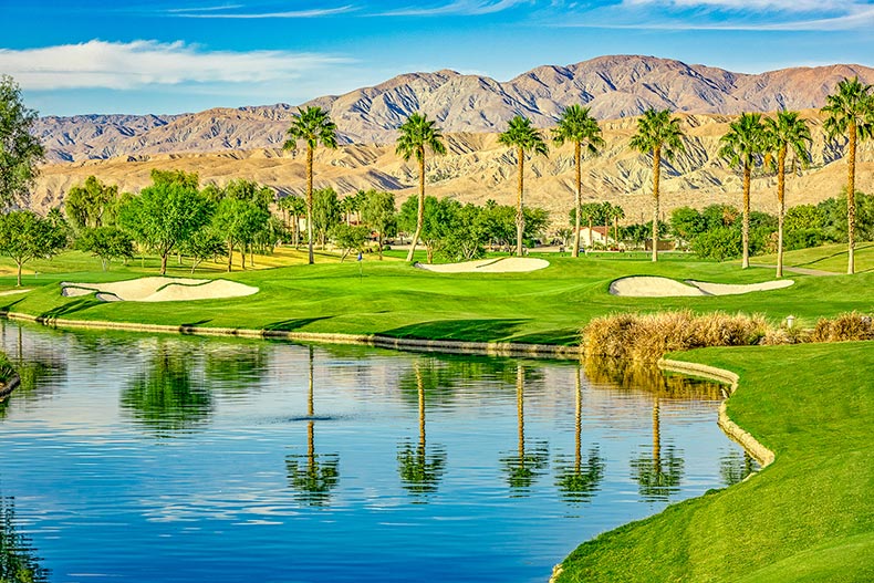 Mountains and palm trees surrounding the golf course and scenic ponds at Sun City Lincoln Hills in Lincoln, California