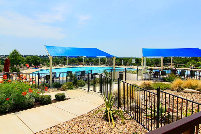 An outdoor resort-style pool and patio at Sun City Texas in Georgetown, Texas