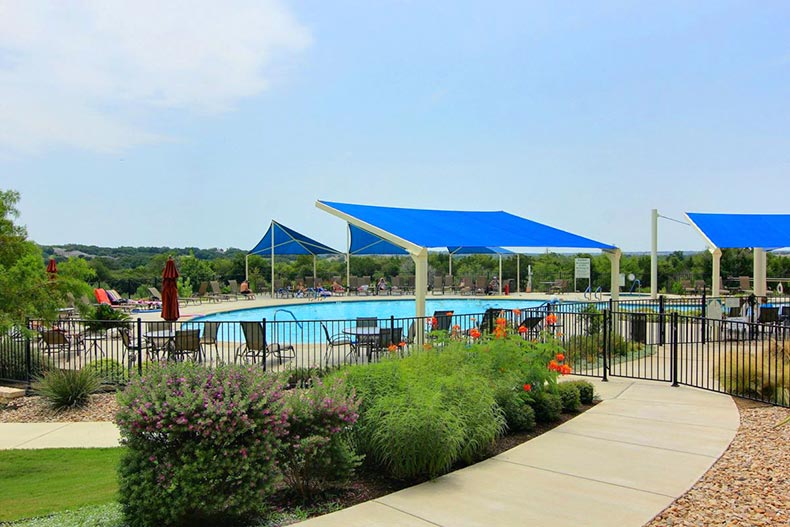 An outdoor pool and patio at Sun City Texas in Georgetown, Texas