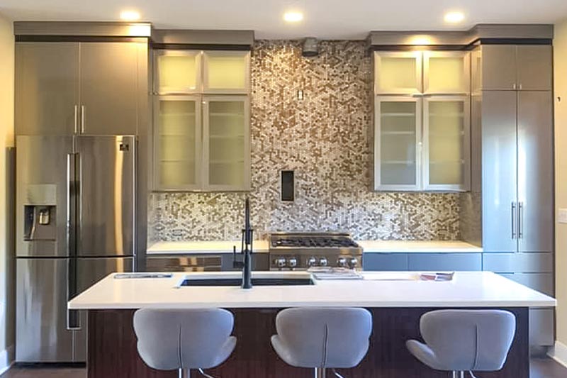 Interior view of a kitchen island overlooking stainless steel appliances.