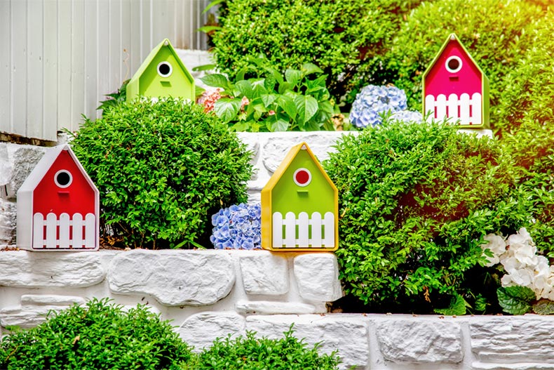 Garden greenery surrounding colorful miniature houses