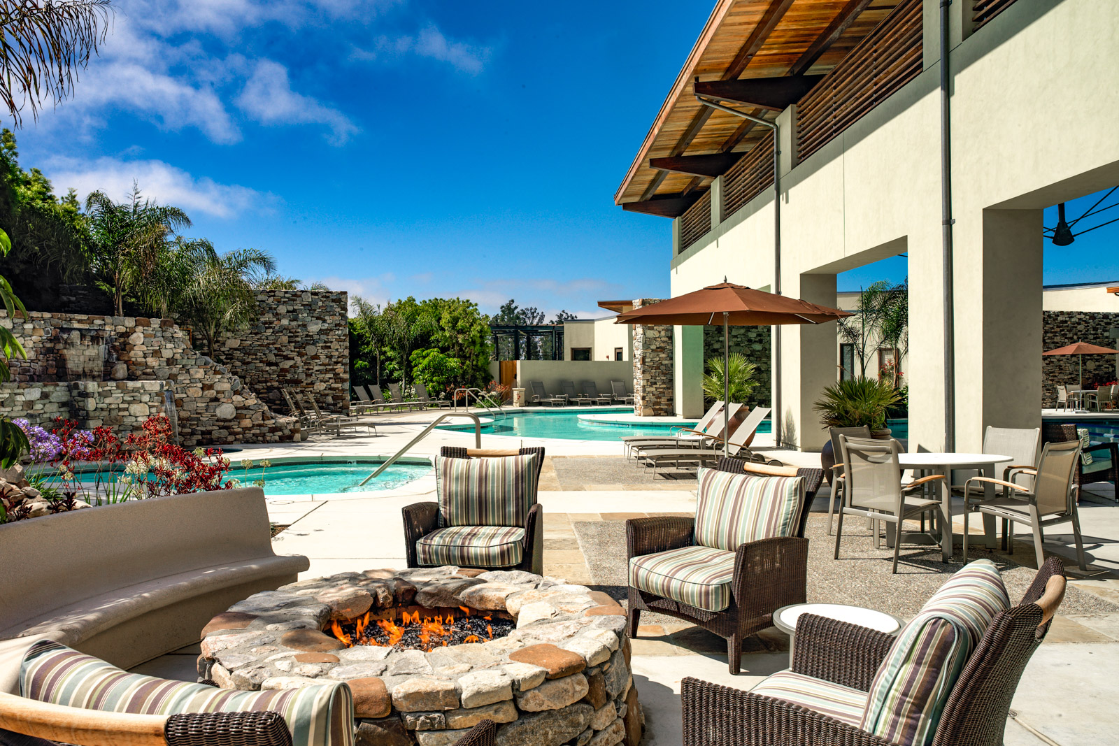 The outdoor pool, spa, patio, and fire pit at Trilogy at Monarch Dunes in Nipomo, California