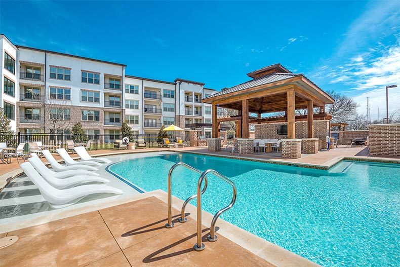 Blue sky over the outdoor pool and patio at Overture Flower Mound in Flower Mound, Texas