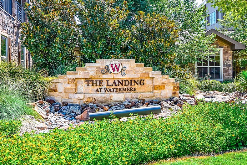 Blooming greenery around the community sign for Watermere at Southlake in Southlake, Texas
